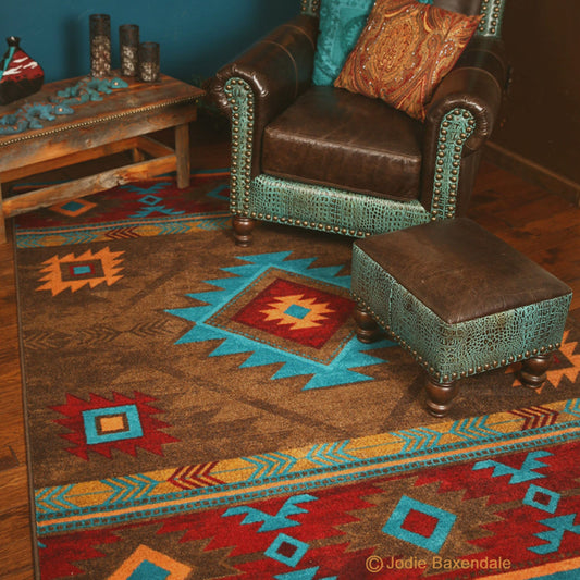 Sitting area with a patterned rug, brown leather chair, and matching ottoman.