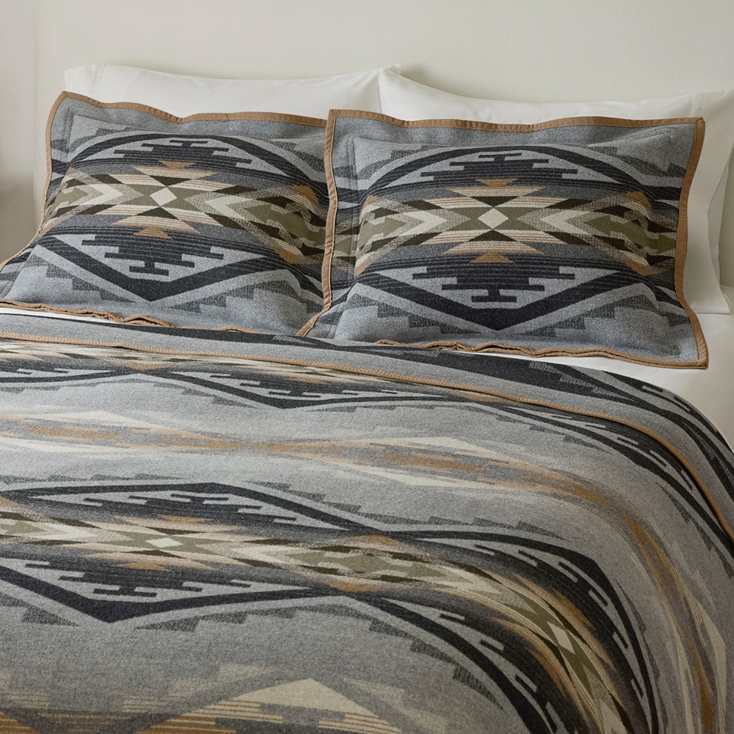 Bedding set with geometric pattern on a bed